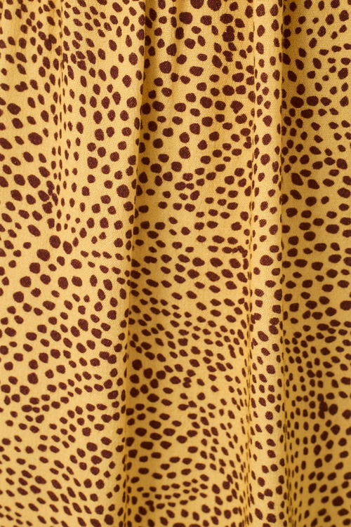 Close-up of yellow fabric with cheetah print pattern