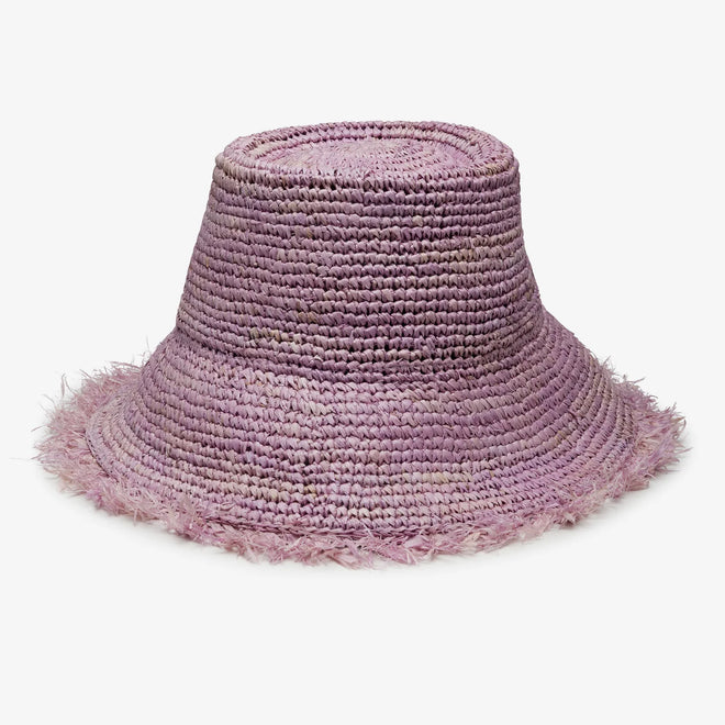 Purple straw hat with frayed edge on a white background