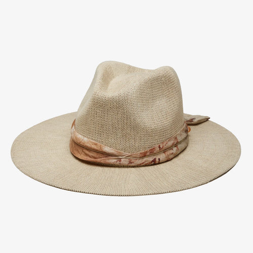 A cream straw hat with a ribbon around the brim against a white background