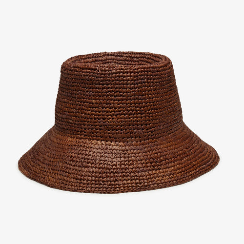 A brown straw bucket hat against a plain background